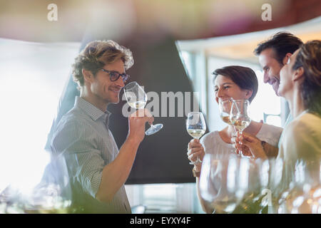 Friends wine tasting in winery tasting room Stock Photo