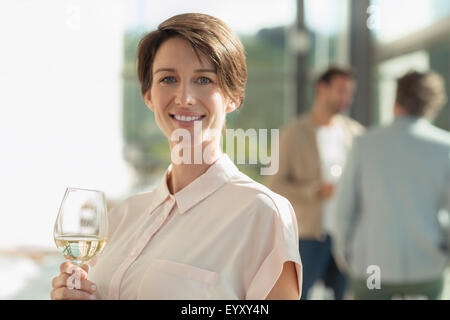 Portrait smiling woman drinking white wine Stock Photo