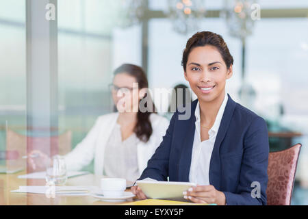 Portrait confident businesswoman using digital tablet Stock Photo