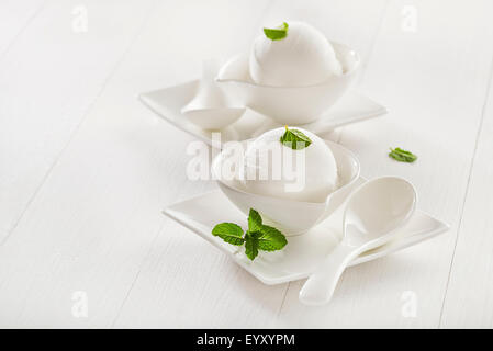 Fresh white ice cream in a white cup. Stock Photo
