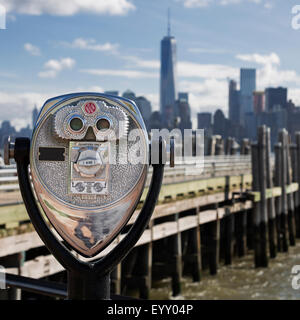 Tourist binoculars at Liberty Island in front of Manhattan Skyline Stock Photo