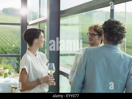 Friends drinking white wine in winery tasting room Stock Photo