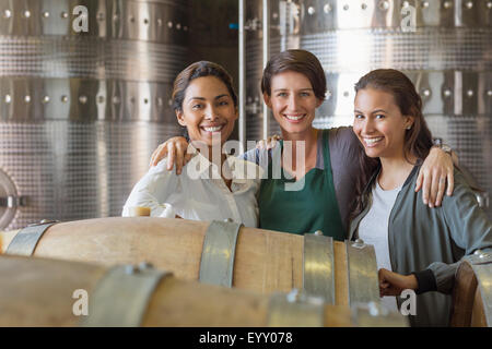 Portrait smiling women in winery cellar Stock Photo