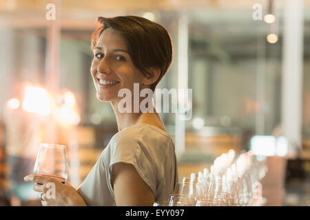 Portrait smiling woman wine tasting at winery tasting room