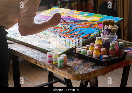 Mari artist painting canvas in studio Stock Photo