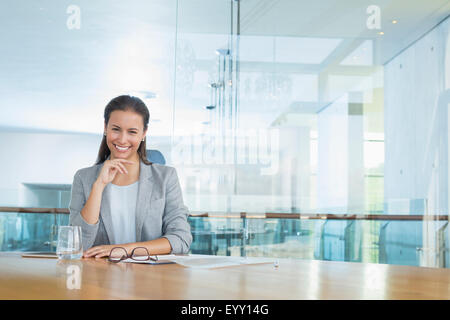 Portrait confident businesswoman at conference room table Stock Photo
