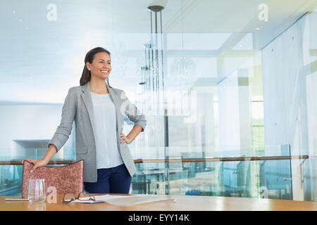 Confident businesswoman in conference room Stock Photo