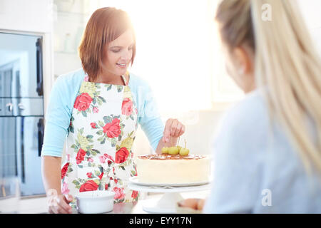 Women baking cake in kitchen Stock Photo