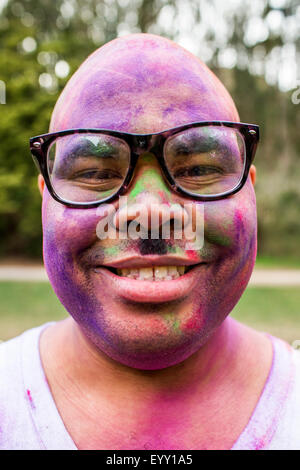 Smiling man covered in pigment powder Stock Photo