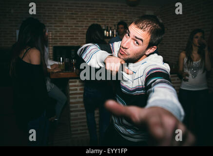 Smiling man dancing in nightclub Stock Photo