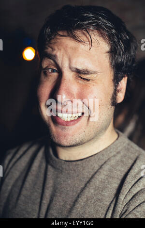 Close up of Hispanic man winking Stock Photo