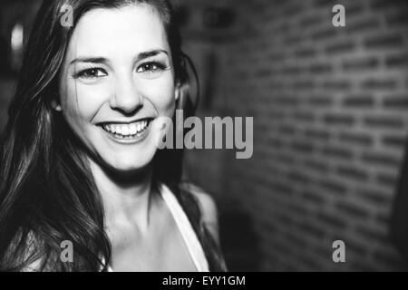 Smiling Caucasian woman laughing in nightclub Stock Photo