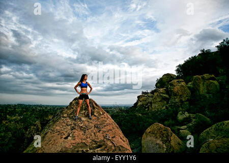 Vietnamese woman standing on rocky hilltop