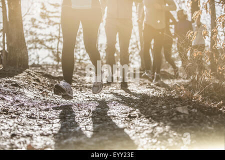Runners jogging on dirt path Stock Photo
