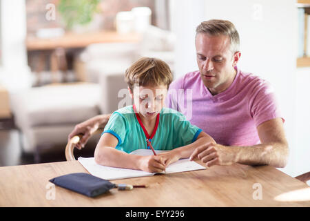 Caucasian father and son drawing at table Stock Photo