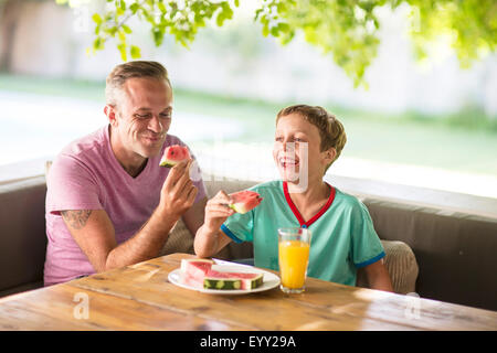 Caucasian father and son eating outdoors Stock Photo
