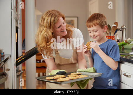 Caucasian mother and son baking cookies in kitchen Stock Photo