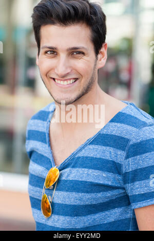 young hispanic man wearing shirt and blue tie posing Stock Photo - Alamy