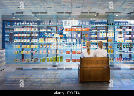 Pharmacists sitting in modern pharmacy Stock Photo