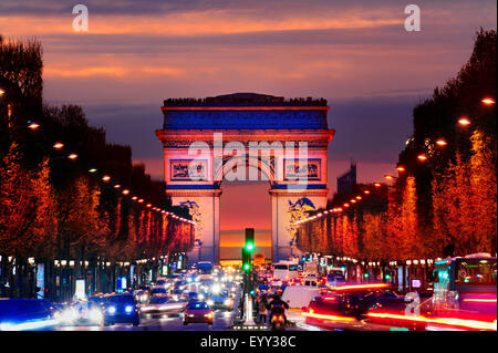 Arc de Triomphe over traffic at night, Paris, Ile-de-France, France Stock Photo