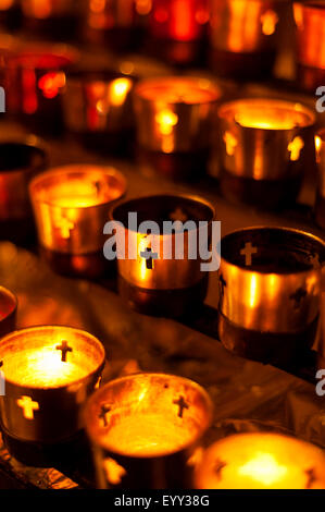 Close up of prayer candles glowing in church