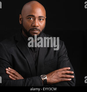 Frowning black businessman with arms crossed Stock Photo