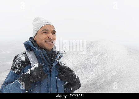 Black man hiking in snow Stock Photo