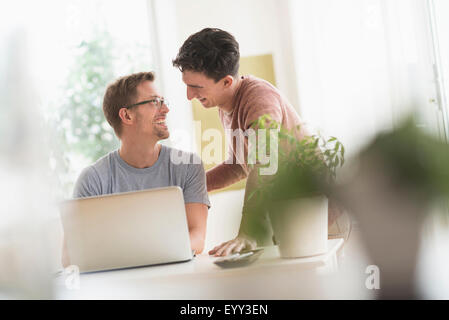 Caucasian gay couple using laptop Stock Photo