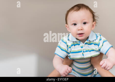 Father lifting Caucasian baby Stock Photo