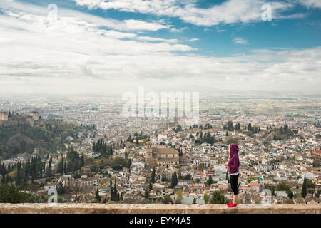 Caucasian woman admiring scenic view of cityscape, Granada, Spain Stock Photo