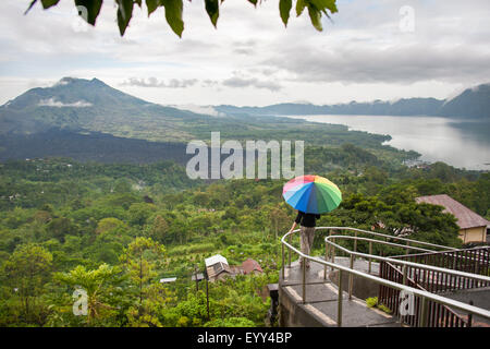 Caucasian tourist admiring scenic view of jungle Stock Photo