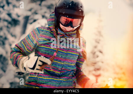 Caucasian girl wearing helmet and goggles in winter Stock Photo