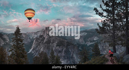 Hot air balloon floating over dramatic mountains, Richmond, Virginia, United States Stock Photo