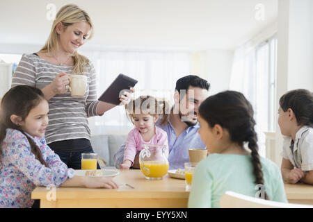 Caucasian family eating breakfast at table Stock Photo