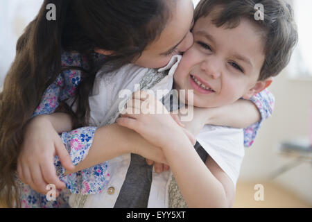 Close up of Caucasian girl kissing brother