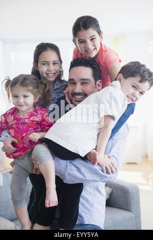 Caucasian father and children relaxing in living room Stock Photo