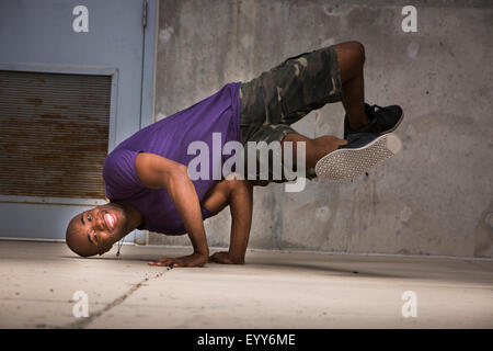 Black dancer balancing on hands Stock Photo