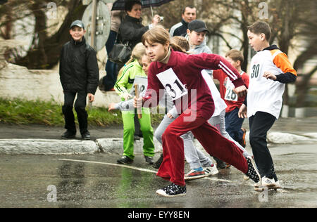 Caucasian children racing on street Stock Photo