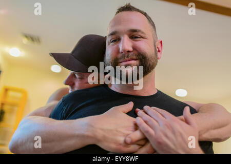 Close up of gay couple hugging Stock Photo
