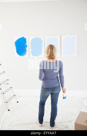 Caucasian woman examining paint samples in new home Stock Photo