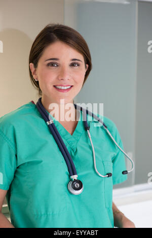 Hispanic doctor wearing stethoscope in hospital Stock Photo