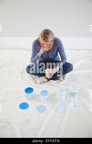 Caucasian woman examining paint samples in new home Stock Photo