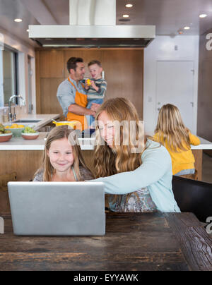 Caucasian family relaxing in kitchen