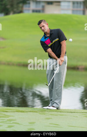 Caucasian man chipping on golf course Stock Photo