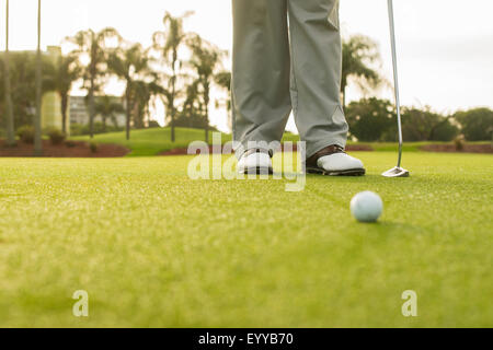 Caucasian man standing on golf course green Stock Photo