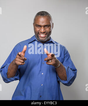 Smiling older African American man pointing Stock Photo