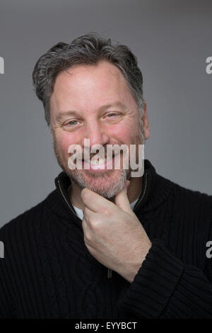 Close up of Caucasian man scratching his chin Stock Photo