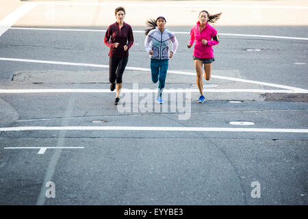 High angle view of women running in city street Stock Photo