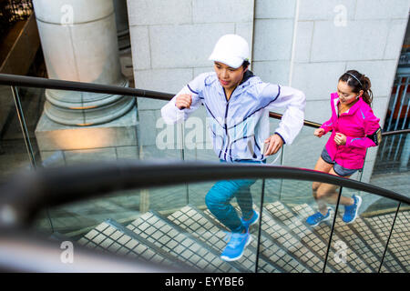 High angle view of women running on staircase Stock Photo