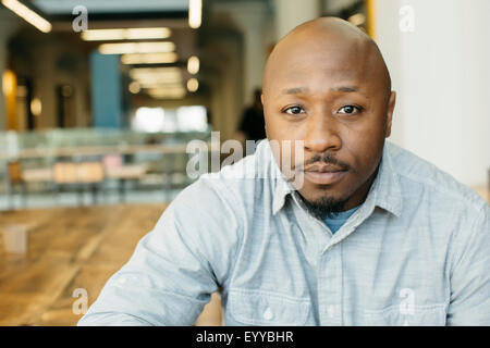 Black man sitting in cafe Stock Photo